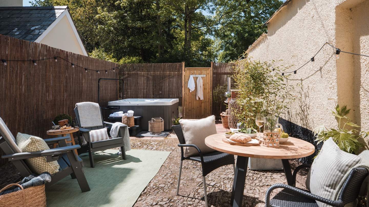 For alfresco meals and moments in the sunshine, it features a table and chairs, as well as two Adirondack lounger chairs adorned with throws