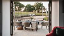 A slate dining table for six sits before the large patio doors 