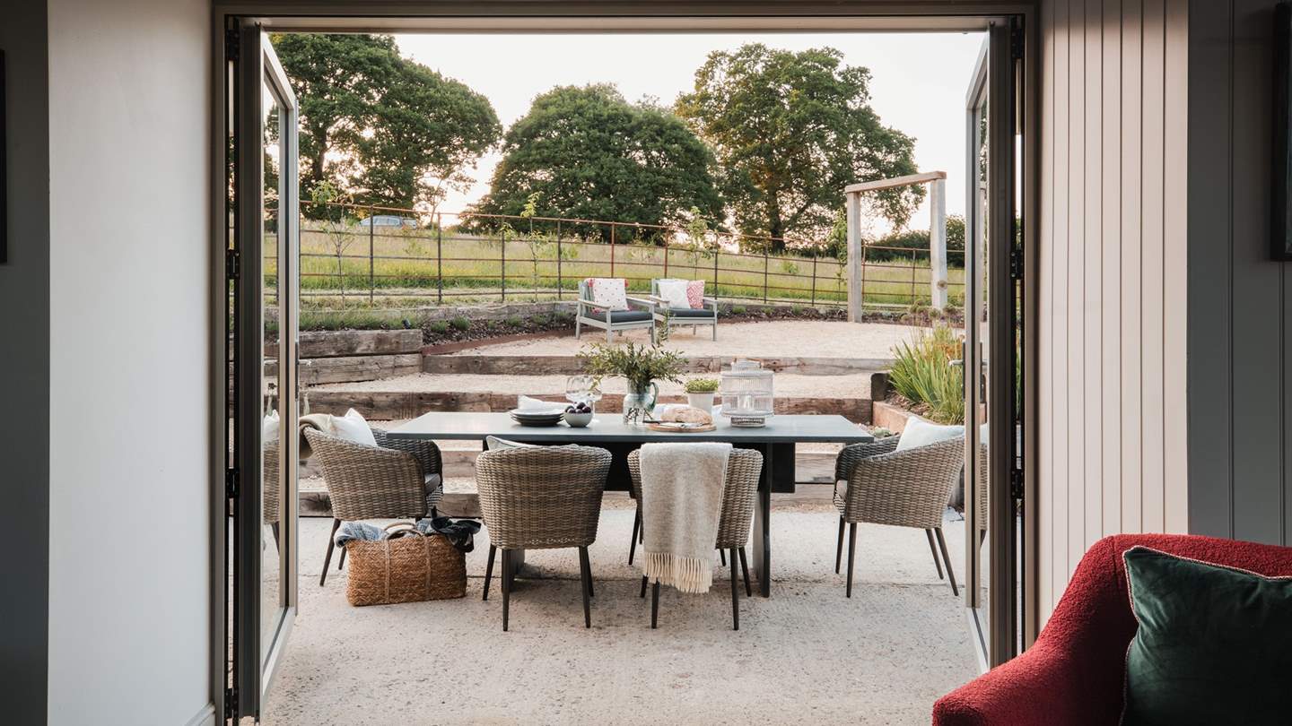 A slate dining table for six sits before the large patio doors 