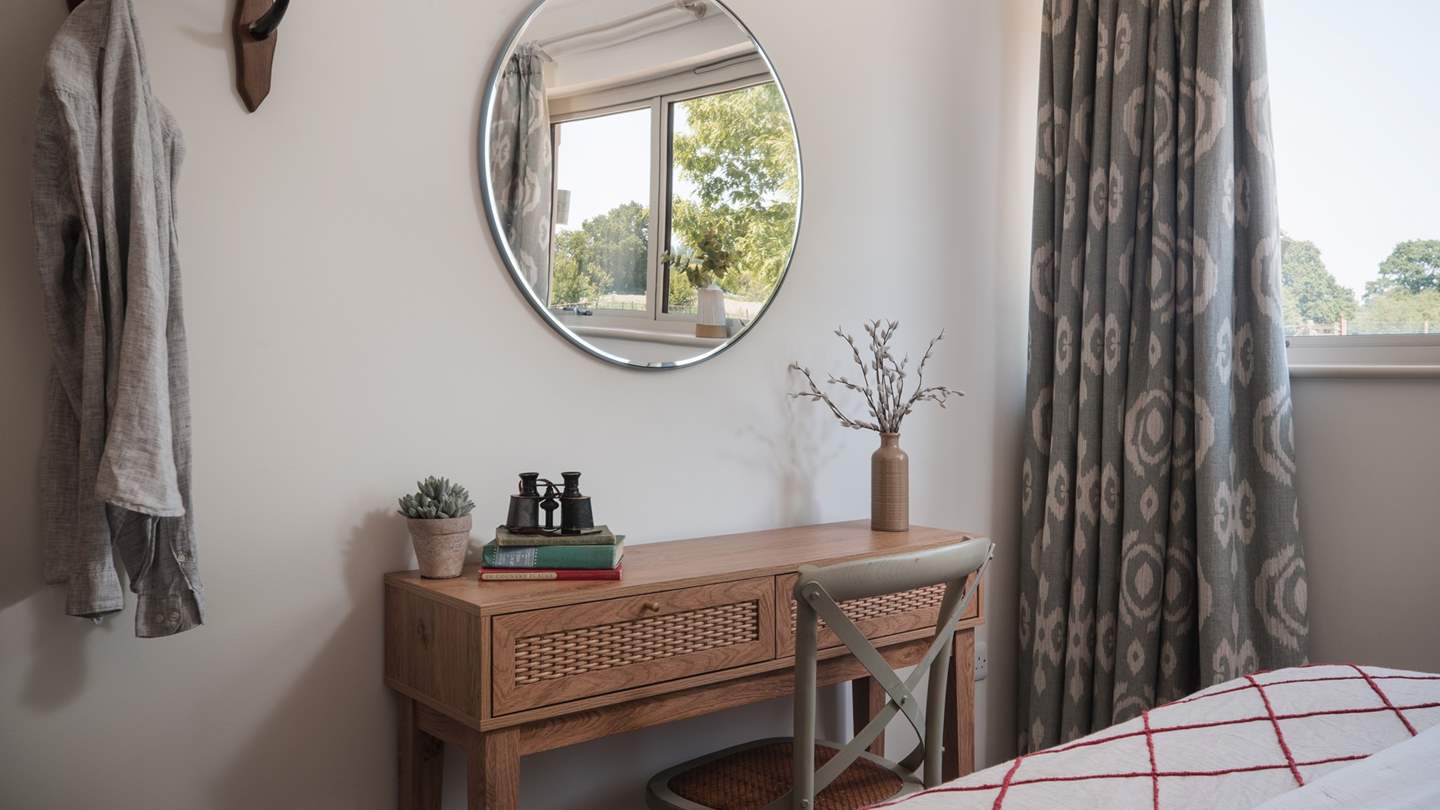 At the foot of the bed, you will find a rustic dressing table, which also makes for a fantastic desk space should you need to catch up on an email or two during your stay