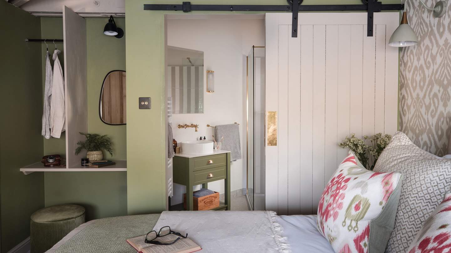 An open wardrobe and dressing table are marvellously tucked away in a cute alcove, whilst an antique dresser sits before the blissful bed to store your belongings
