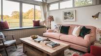Curl up with your latest page turner on the dusky pink sofa 