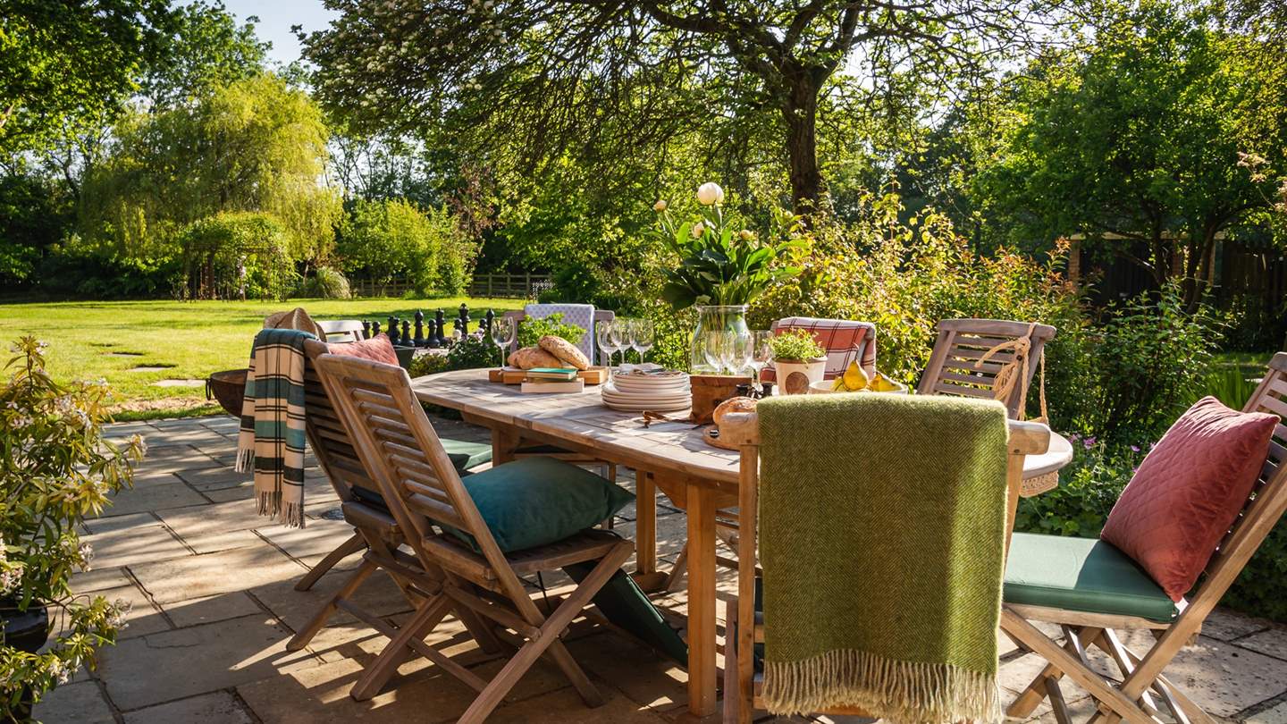 A large wooden table with ten chairs enjoys a serenely peaceful setting