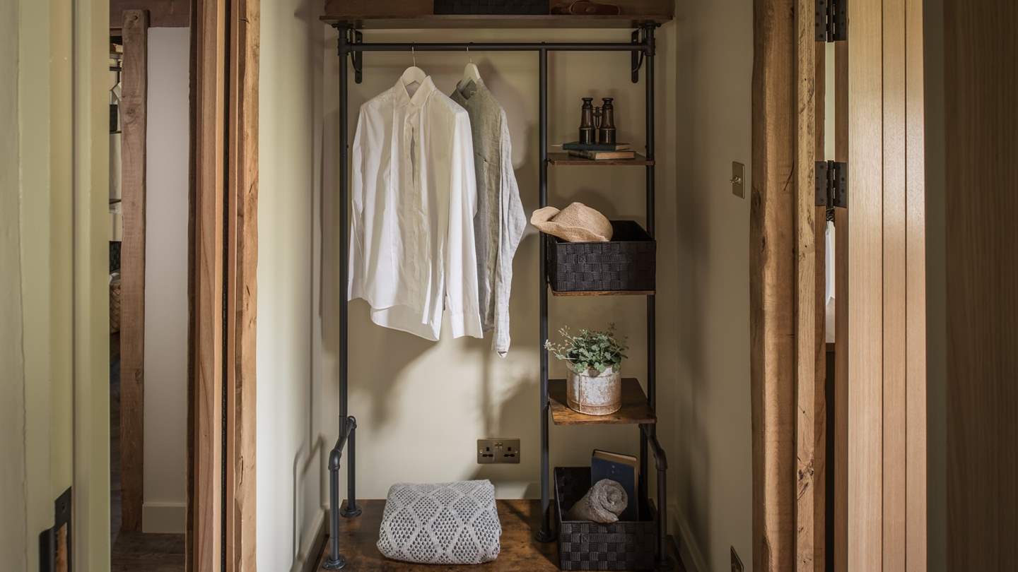You’ll find an en suite and hanging storage adjacent to the room, with gorgeous, exposed brick and wooden detailing