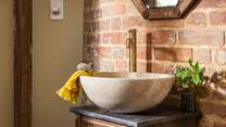 The stone basin is just stunning and pairs perfectly with the natural essence of the space