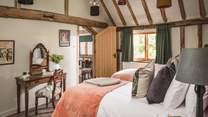 Beautiful, vaulted ceilings with exposed beams craft a truly spellbinding aesthetic in bedroom four