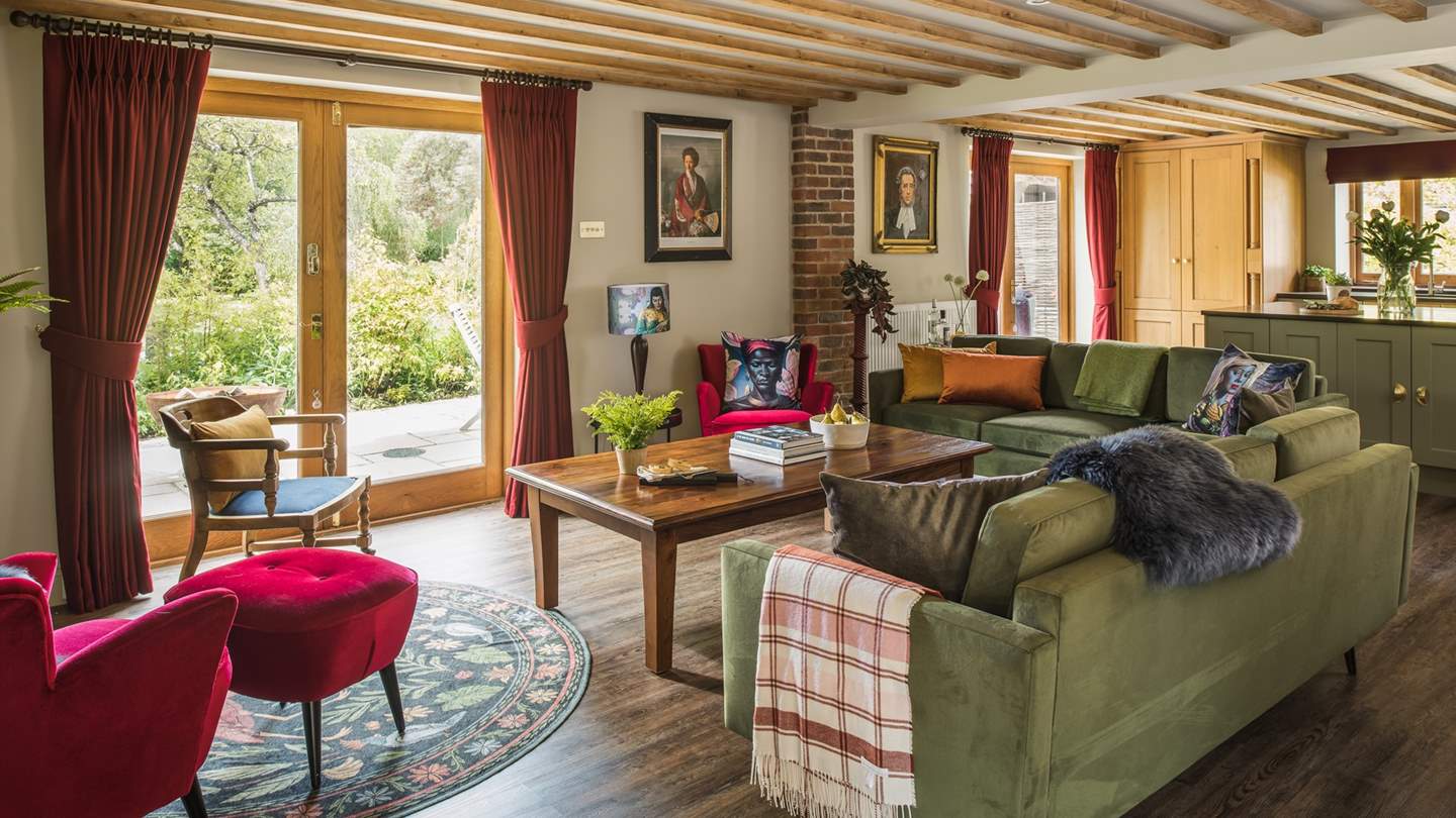 Sink into the velvet touch of one of the two sumptuous sofas, each adorned with bright and beautiful cushions