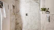 With marble tiling, residing with a spacious walk-in shower