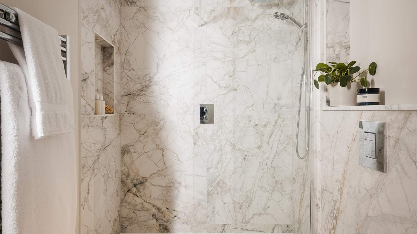With marble tiling, residing with a spacious walk-in shower