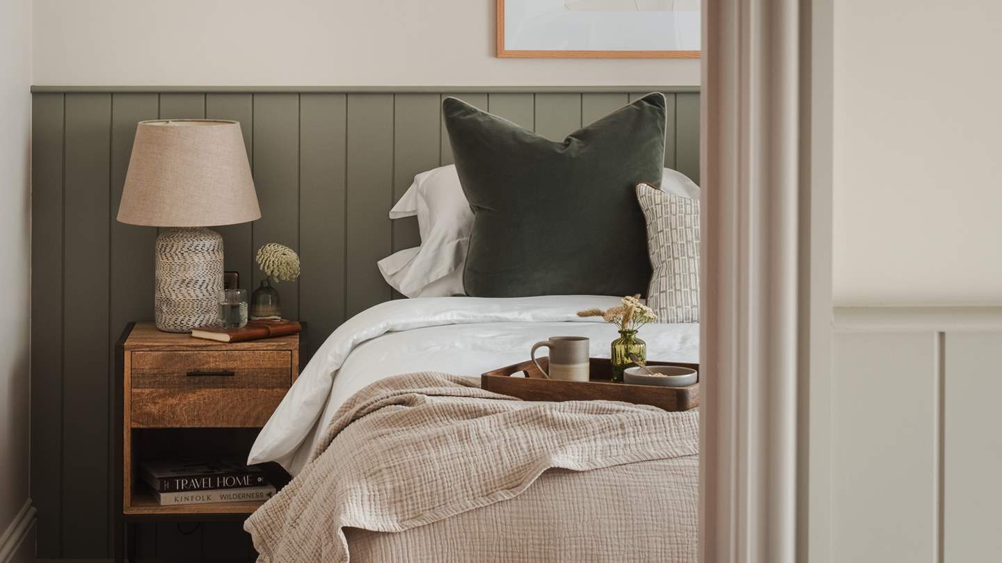 The first of the ground floor bedrooms enjoys stunning garden views through large patio doors