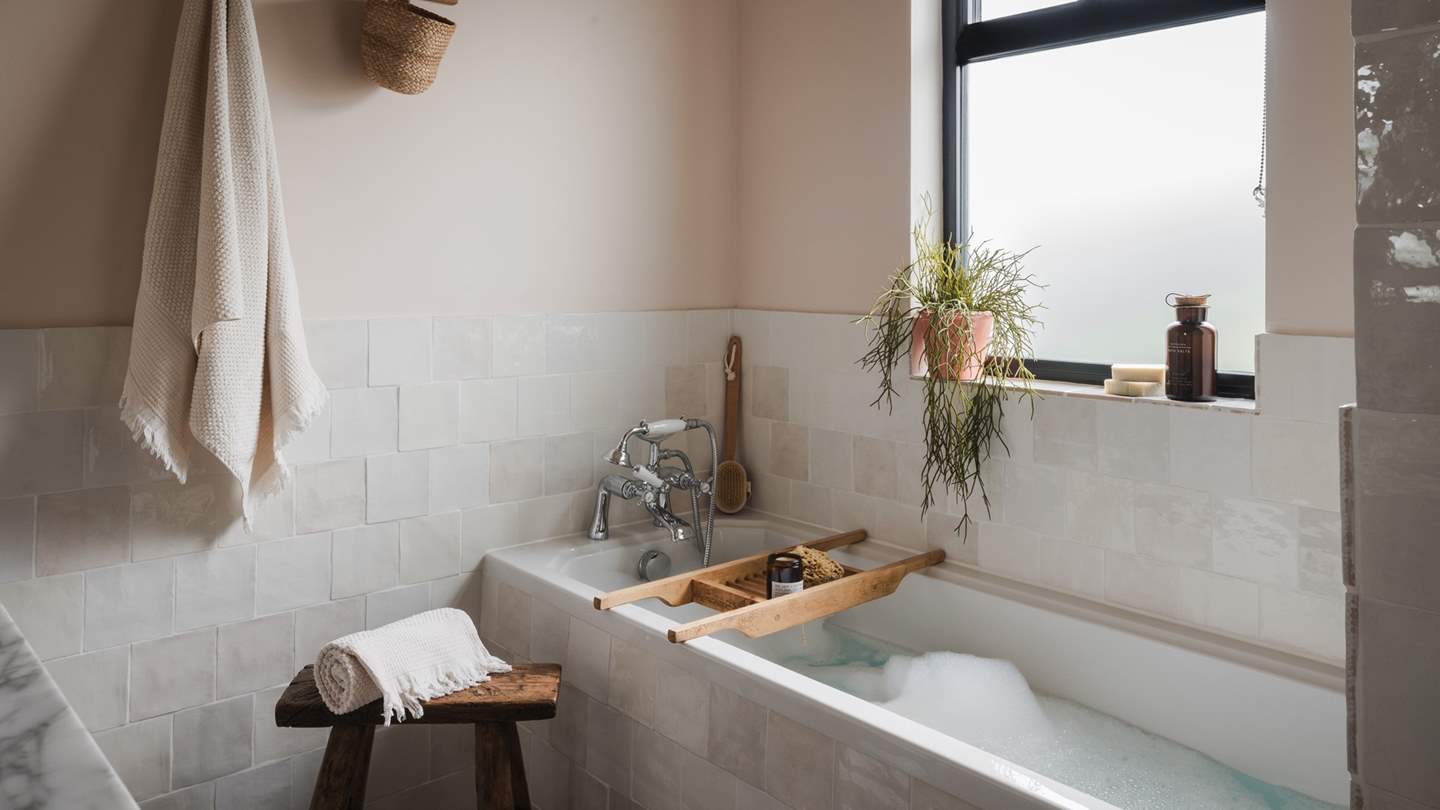 A family bathroom in neutral tones offers a soul-soothing space to unwind