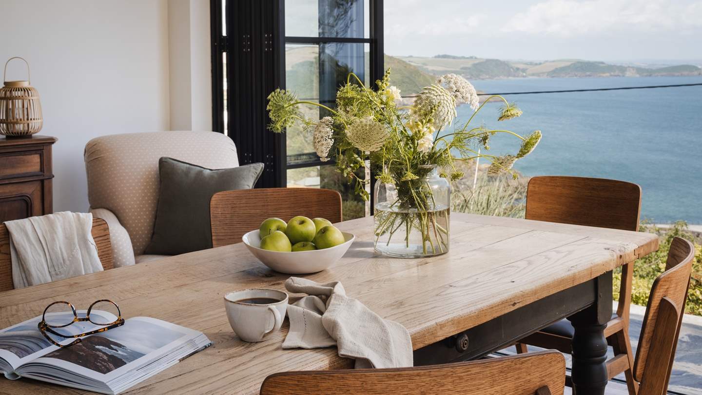 A large Critall-style glass open-plan kitchen and dining space accentuate the cottage's  oceanside position