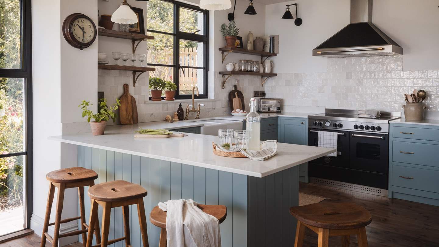 At the opposite end of this captivating space is the elegant kitchen, divided by a breakfast bar feature with four barstools