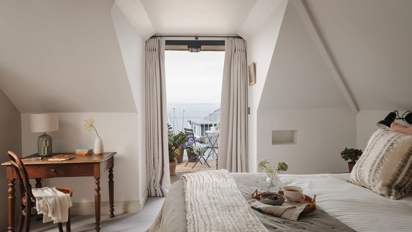 This sumptuous bedroom boasts French doors leading to a balcony... 