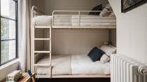 The snug bunk bedroom is an adorable hangout for the little ones