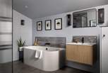 The ensuite bathroom is a sleek, modern space, complete with a large walk-in shower and free-standing bath