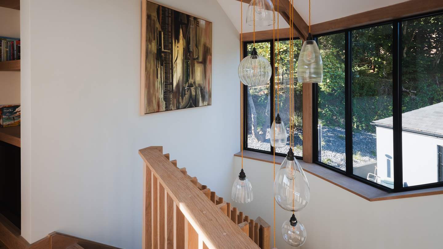 We just adore the contemporary pendant feature lighting on the staircase... 