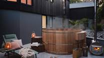 Uncover the cedar clad hot tub, settled in the contemporary, open-air inner courtyard complete with flourishing palms...