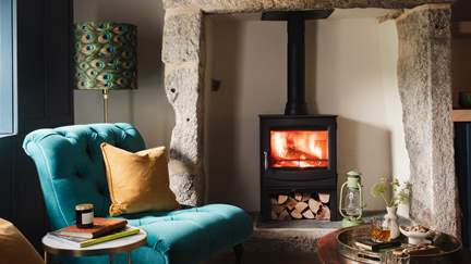 The exposed stone fireplace promises evenings of cosiness and calm