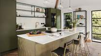 Uncover the open-plan kitchen and dining room, emulating the verdant shades throughout Melynsy 