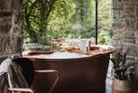 The copper bathtub a bewitching spot to indulge in the divine woodland backdrop with low lighting and a soulful soundtrack...