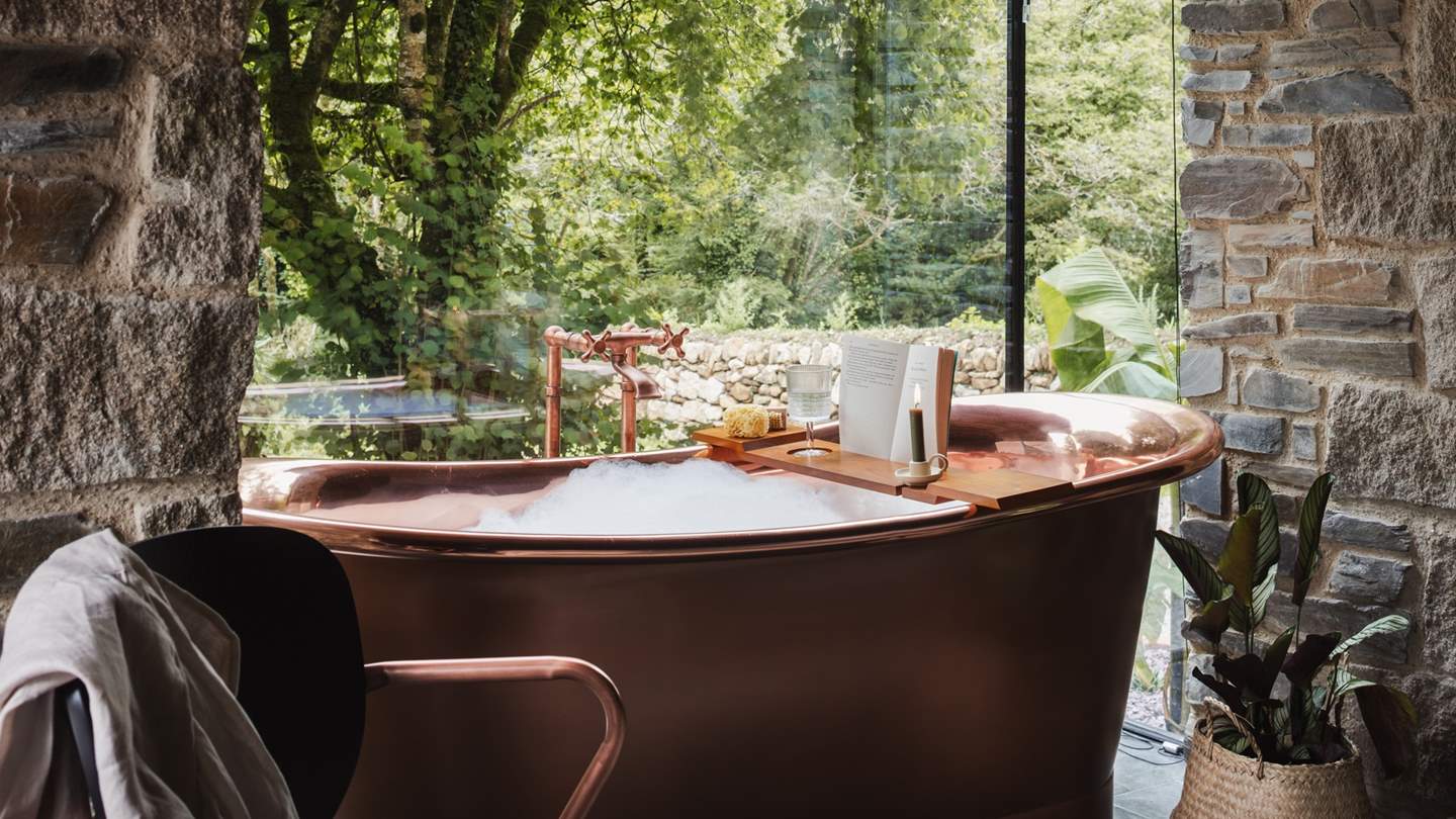 The copper bathtub a bewitching spot to indulge in the divine woodland backdrop with low lighting and a soulful soundtrack...