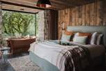 The cabin-style master bedroom promises rustic charm throughout... 