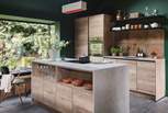 A stylish breakfast bar divides the living area from the sumptuous kitchen space