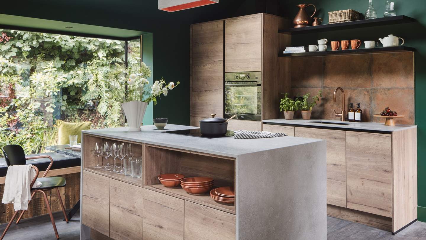 A stylish breakfast bar divides the living area from the sumptuous kitchen space