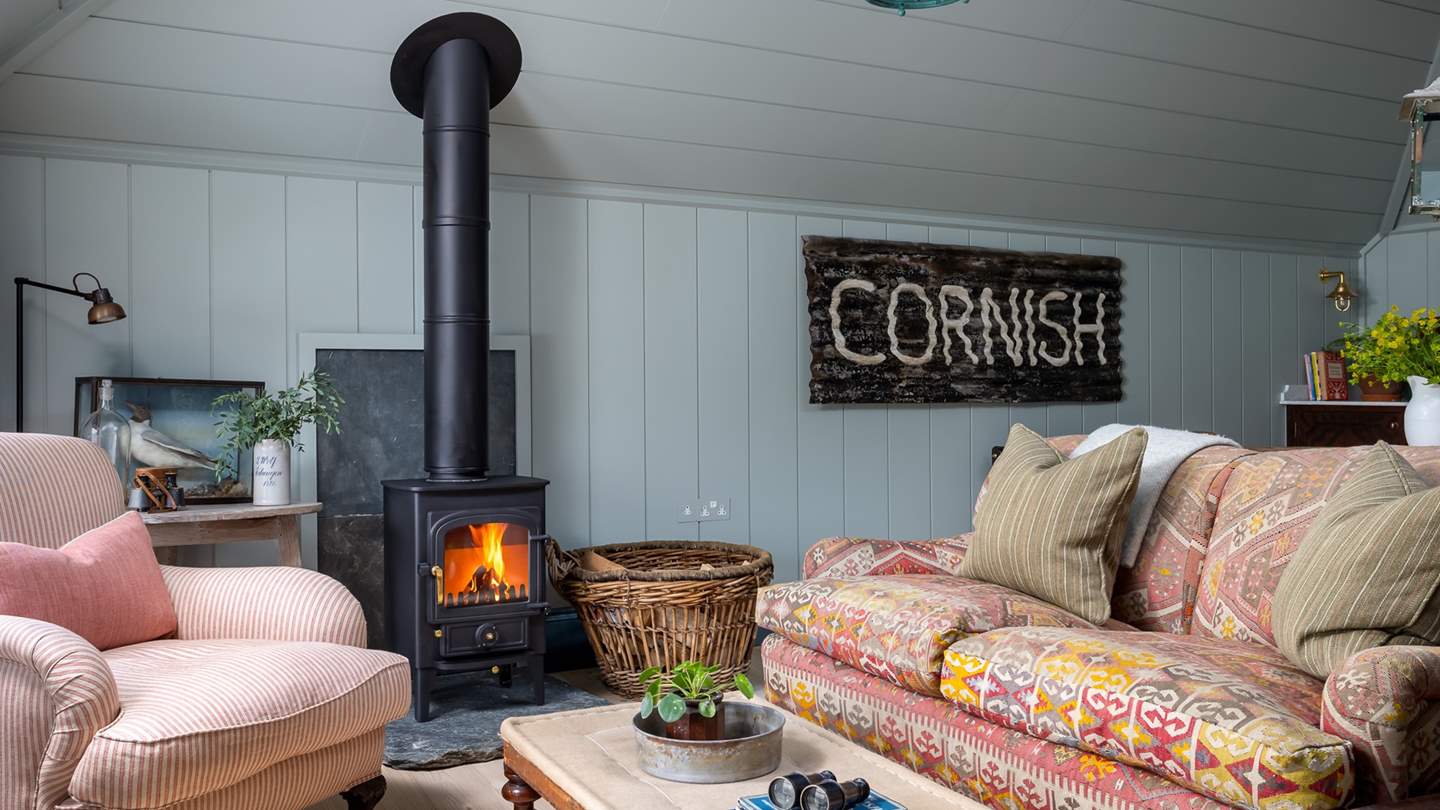 Retreat to the far side of the room for cosy moments fireside, with a sweet wood burning stove