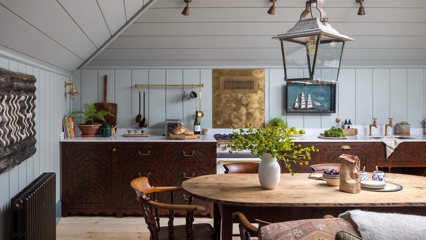 On the opposite side of the room, you will find the beautiful bespoke kitchen and dining table 