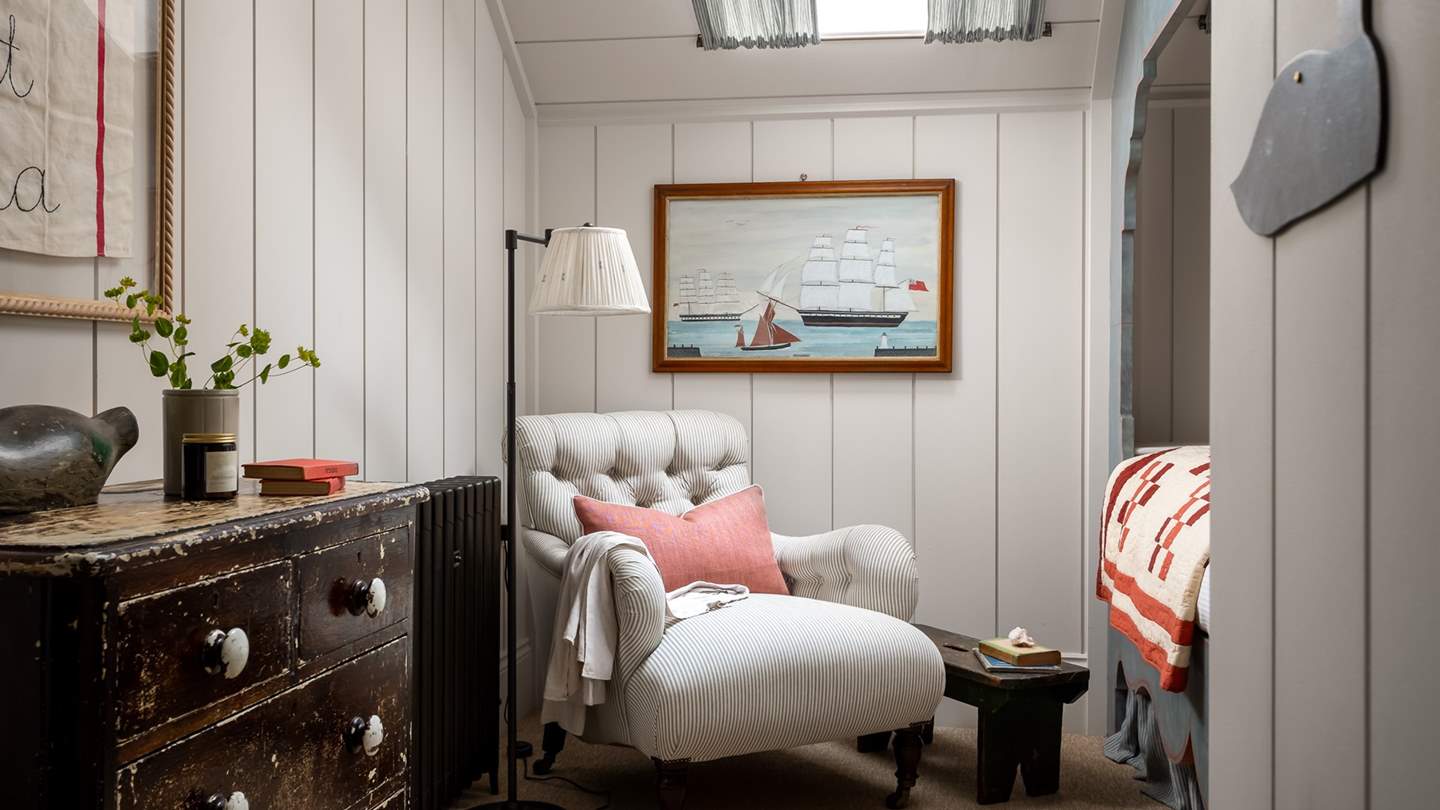 Store your belongings in the antique chest of drawers, with the addition of a comfortable armchair for moments of quietude with your current read