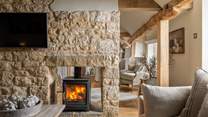 A double-sided wood burner creates a cosy atmosphere throughout the cottage 