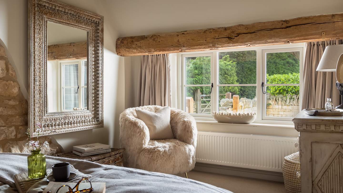 For storing your belongings, you’ll find a rustic chest of drawers, plus a beautifully stylish accent chair