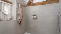 A large walk-in shower awaits for refreshing wake-me-up moments