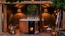 For soothing dips at dusk, a wood-fired hot tub is nestled beneath a walled canopy for the utmost privacy