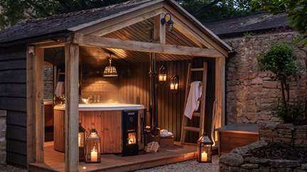 Step outside to uncover a dreamy wood-fired hot tub, nestled beneath twinkling lights