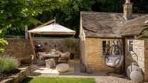 Savour alfresco feasts around the sleek dining table, with an Ooni pizza oven and a charcoal barbeque which doubles up as a firepit 