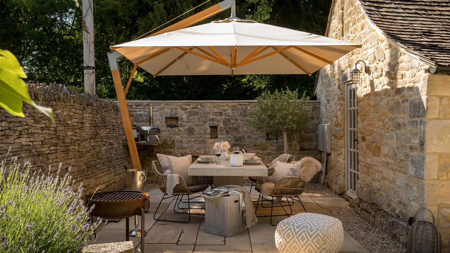 A sleek dining table with rattan chairs for four is perfectly positioned to bask in the sun on balmy summer days, savouring alfresco feasts with your special someone