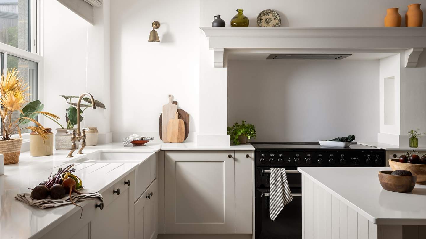 A beautiful island offers additional counter space, as well as three rustic bar stools, making socialising in the kitchen an utter dream