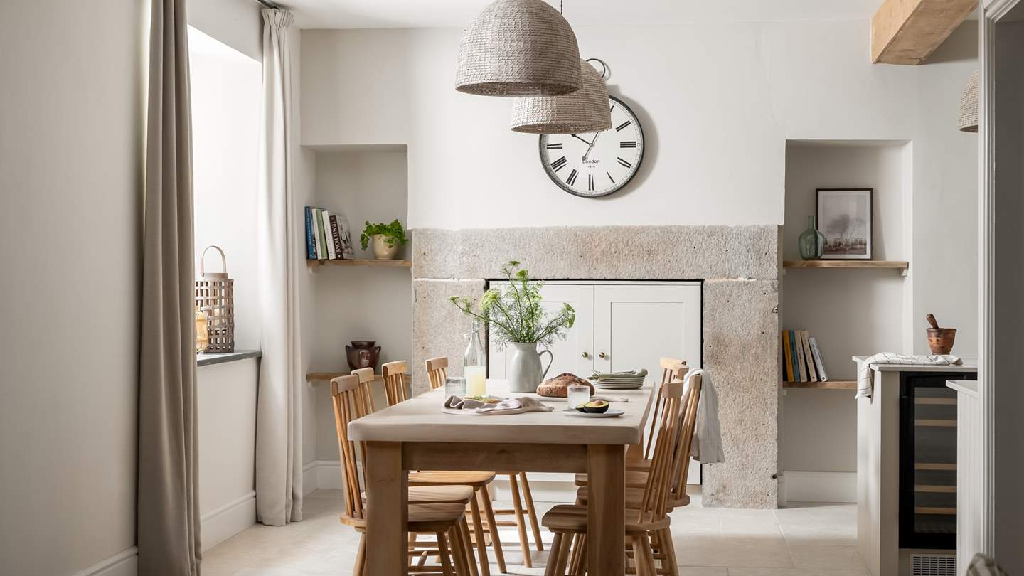 Sitting between the kitchen and the snug, a large wooden dining table is the perfect place to share meals and memories