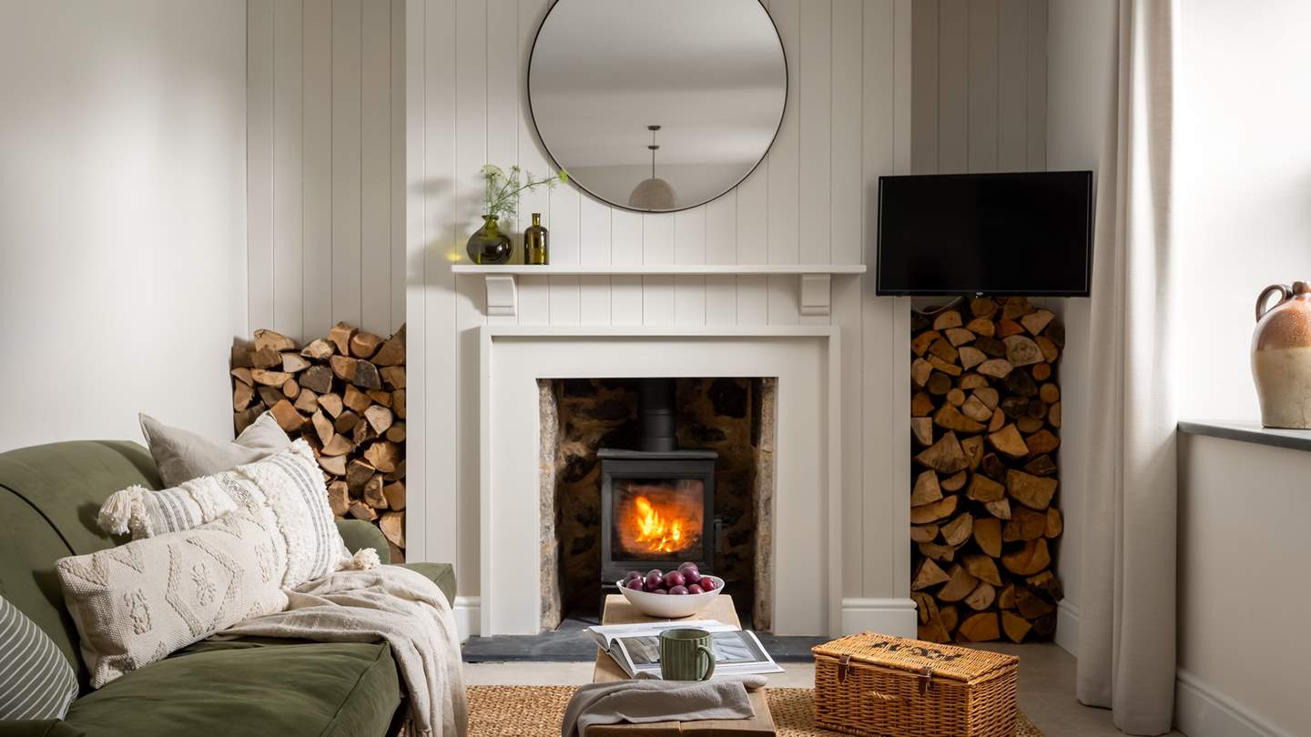 Sink into the sumptuous green velvet Cotswold Company sofa and flick on the wall-mounted TV, or drift into your holiday read