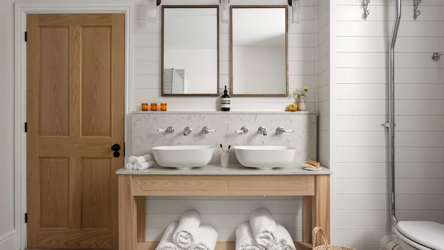 Double vanity sinks with marble accents ensure you have everything you need at your fingertips