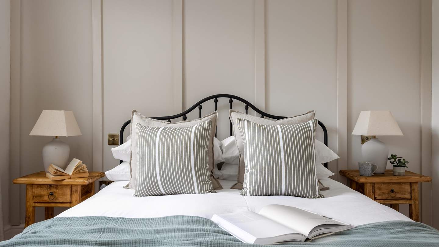 A sleek metal frame king size bed beckons for a night of deep rest...