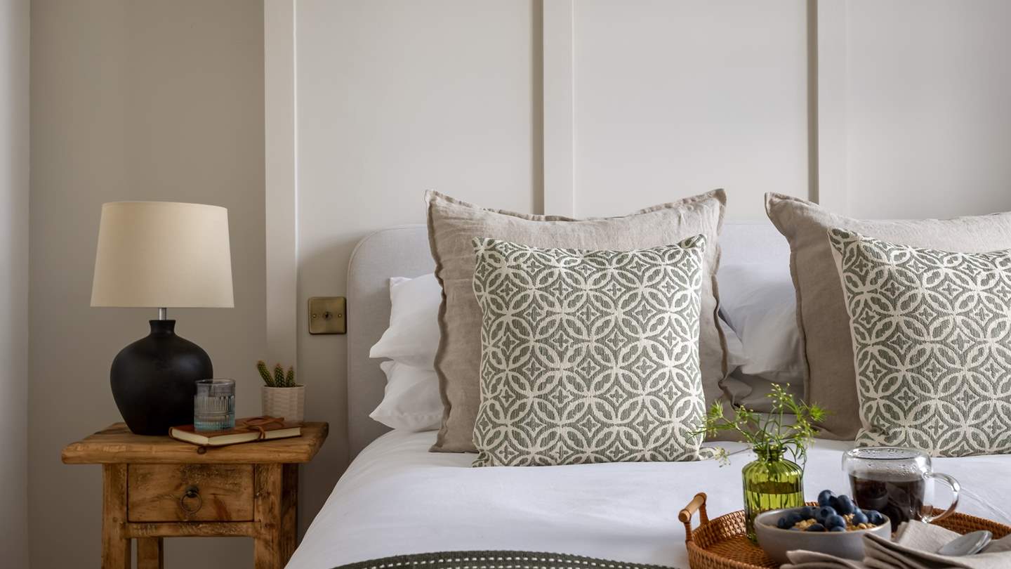 Rich, wooden bedside tables offer a place to rest your morning coffee