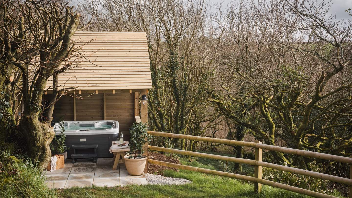 Stretching down to the sheltered wooden pergola where the bubbling hot tub awaits