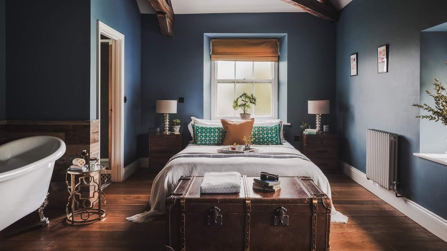 Uncover the master bedroom, where tones of midnight blue and mustard promise a serene setting to slumber