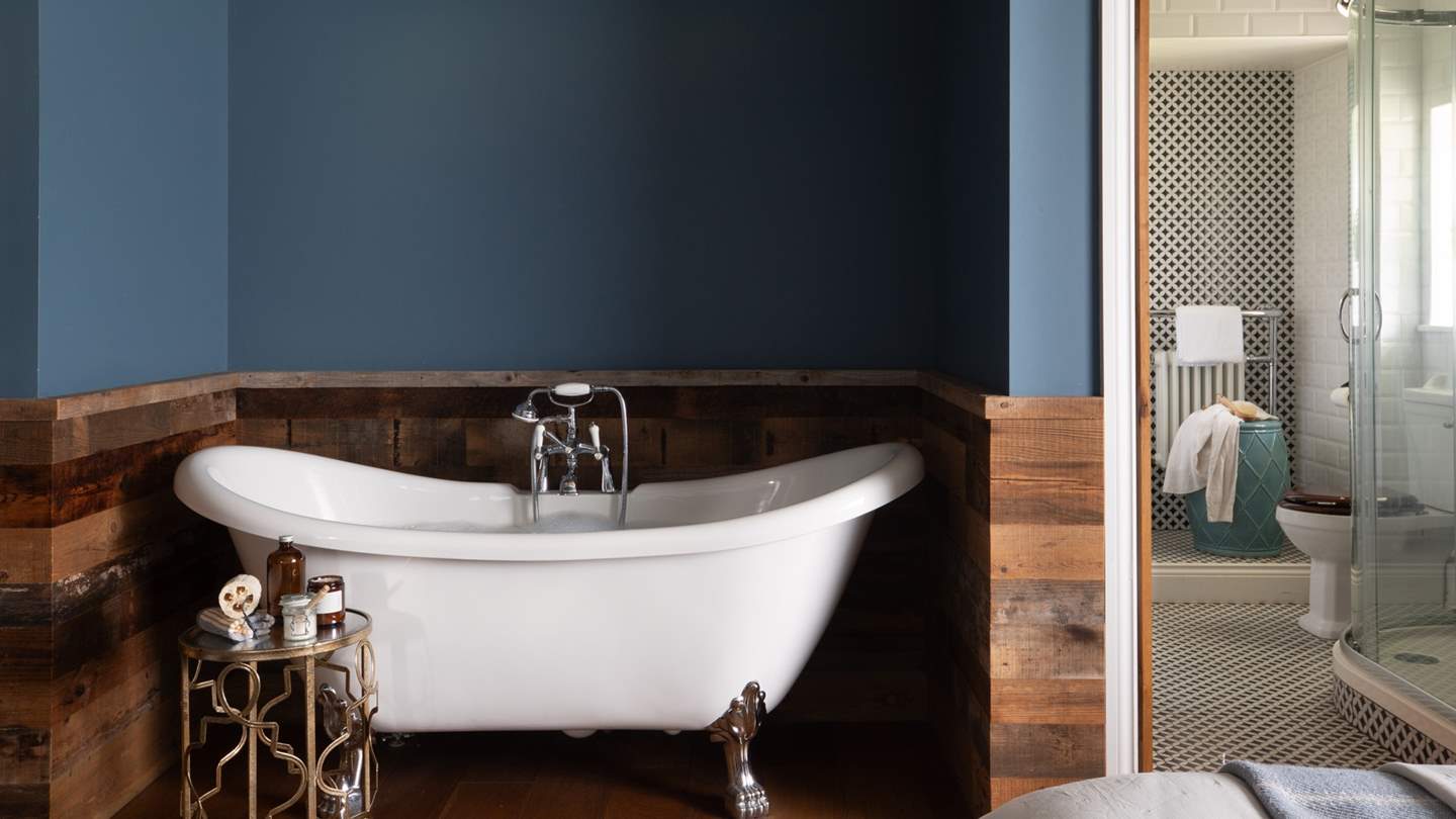 A pretty clawfoot bathtub exists for bubble-topped moments...