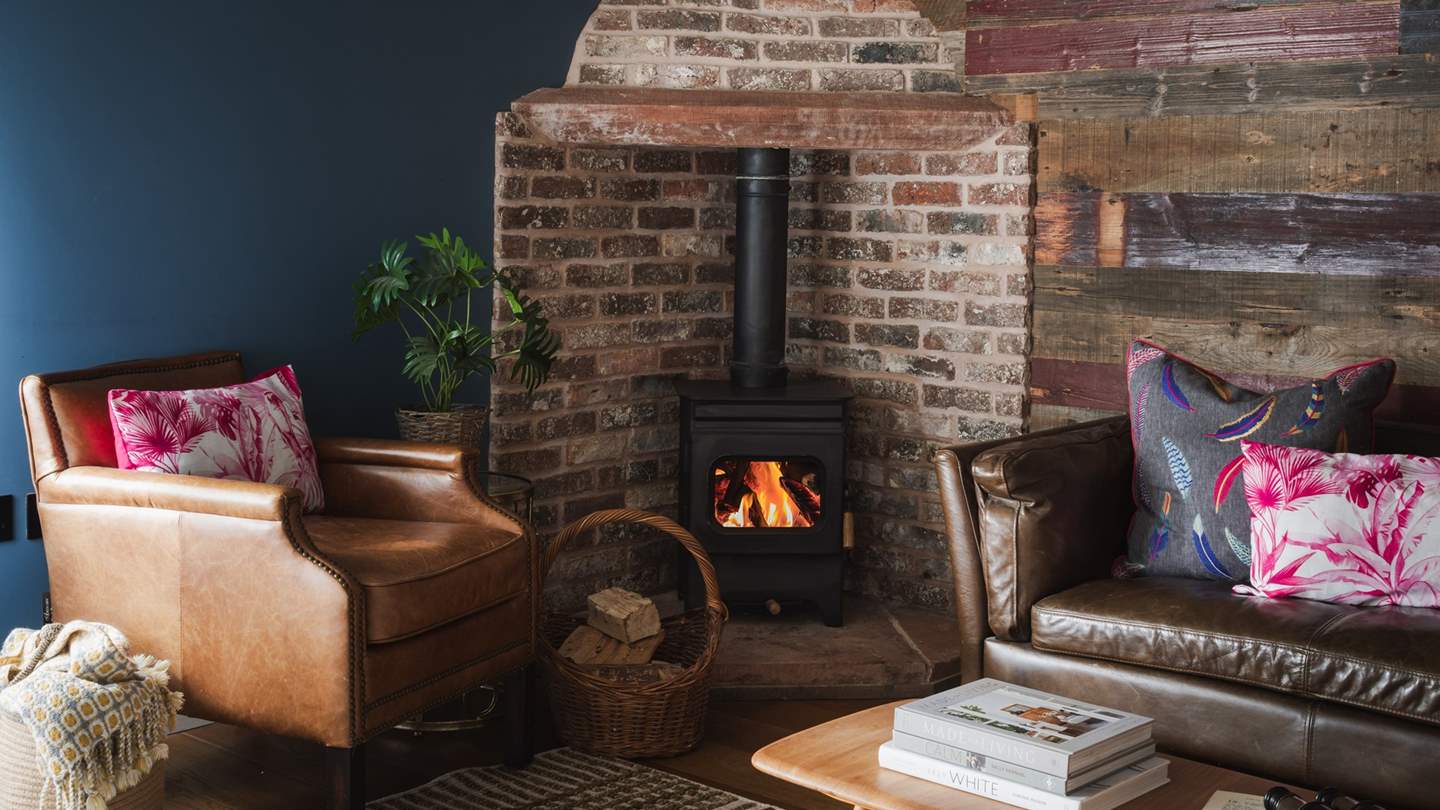 A wood burning stove is a unique addition to this stunning bedroom