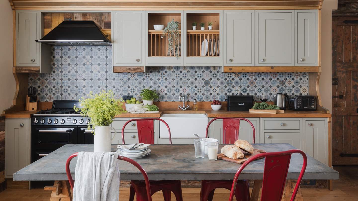Pretty geometric tiling and bespoke, sage-toned cabinets ensure a dreamy setting for crafting culinary treasures...